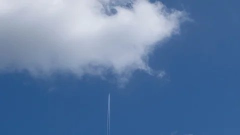Airplane flying on deep blue sky with chemical direction trails,transportation Stock Footage 115772996