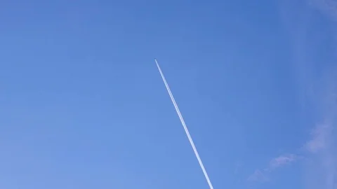 Airplane flying on deep blue sky with chemical vapor trails,tourism transport Stock Footage 124683815