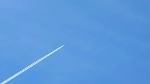 Airplane flying on deep blue sky with chemical direction trails,transportation Stock Footage 155288989