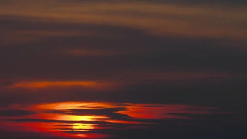 Airplane flying in dramatic sunset sky with glowing sun Stock Footage 338189005