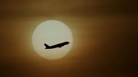 Airplane Flying in front of Large Sun at Sunset Sky Video stock 88621010