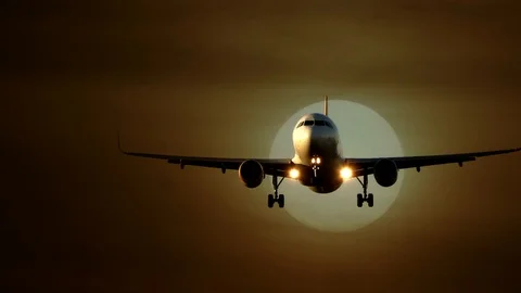 Airplane Flying in front of Large Sun at Sunset Sky Video stock 88621334
