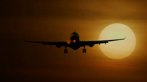 Airplane Flying in front of Large Sun at Sunset Sky Stock-Footage 88622085