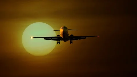 Airplane Flying in front of sun at sunset sky Stock-Footage 88621254