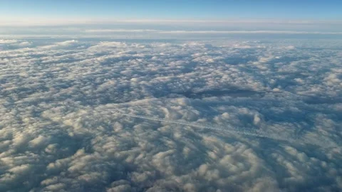 Airplane flying high above clouds with contrail seen from cockpit Stock Footage 276699673