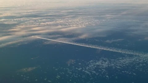 Airplane flying high above clouds with contrail from cockpit 動画素材 276700611