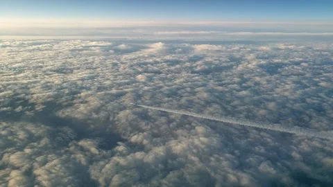 Airplane flying high above clouds with contrail from cockpit view Stock Footage 277519582
