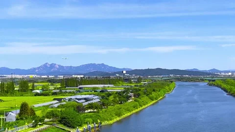 An airplane flying low over a river Stock Footage 254877264