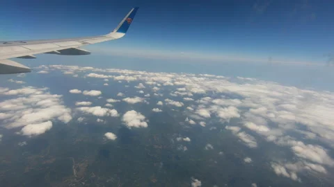 Airplane flying low, white clouds 스톡 동영상 235740209