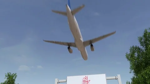 Airplane flying over advertising billboard with Emirates Airline logo. Editorial Stock Footage