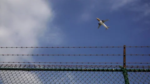 Airplane Flying over a Barbed Wire Stock Footage 63443220