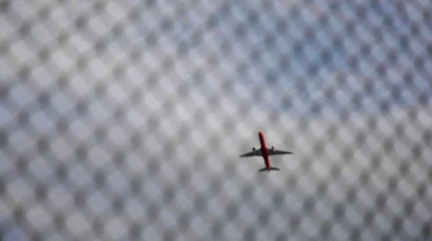 Airplane Flying over a Barbed Wire - Defocus at the end of the shot Stock Footage 63443491