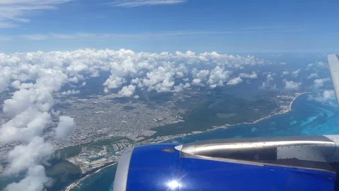 Airplane flying over beautiful blue sea Cancun Mexico Stock Footage 88549533