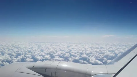 Airplane Flying Over a Blanket of Clouds High in the Sky Stock Footage 150931936