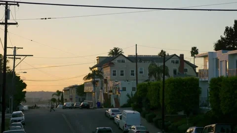 Airplane flying over a city street at sunset in 4k Stock-Footage 282472953