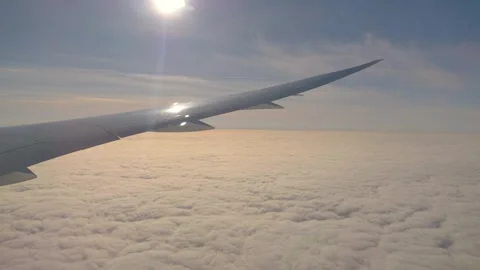 Airplane flying over clouds in 4k slow motion 60fps Stock Footage 282994333
