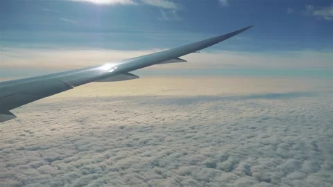 Airplane flying over clouds in 4k slow motion 60fps Stock Footage 282994921