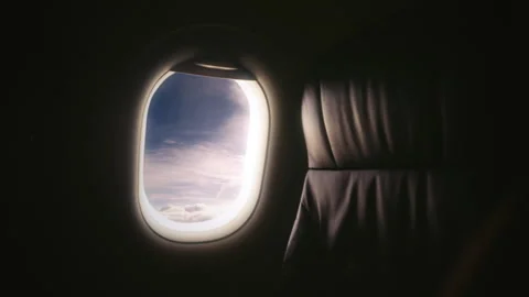 Airplane Flying Over Clouds Window View From Inside Empty Cabin Stock Footage 318608540