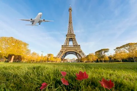 Airplane flying over Eiffel Tower, Paris, France. Eiffel Tower is internation Stock Photos