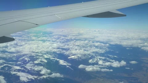 Airplane flying over a mountain range in in 4k slow motion 60fps Stock Footage 282996933