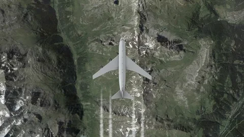 Airplane flying over mountainous terrain with snow-covered peaks Stock Footage 325037962