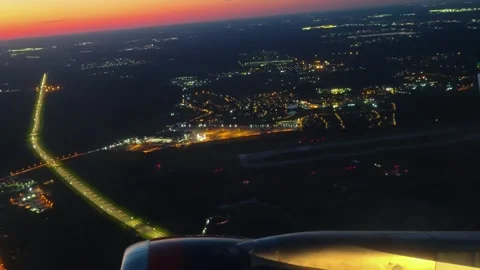 Airplane flying over a night panorama city. View from airplane window. Видео 285497646