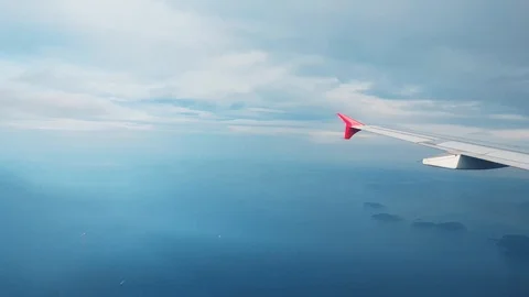 Airplane flying over the sea, view from the window Stock Footage 104411554
