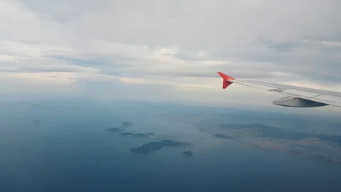 Airplane flying over the sea, view from the window Stock Footage 104411712