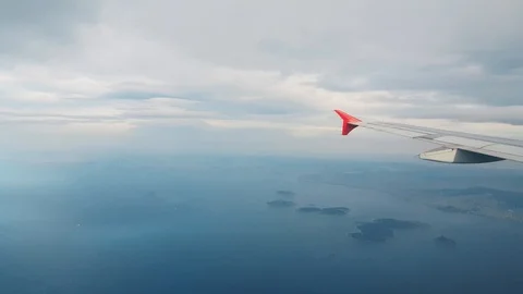 Airplane flying over the sea, view from the window Stock Footage 104411752