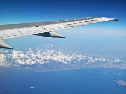 Airplane flying over white clouds Stock-Fotos