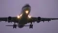 Airplane flying overhead at dusk HD Footage