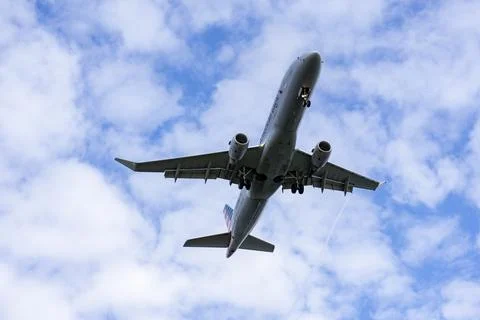 Airplane flying overhead Stock Photos