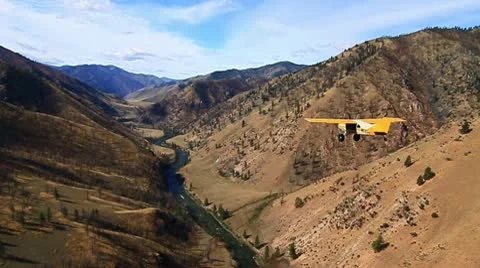 Airplane flying the up the Salmon River Stock Footage 10702786