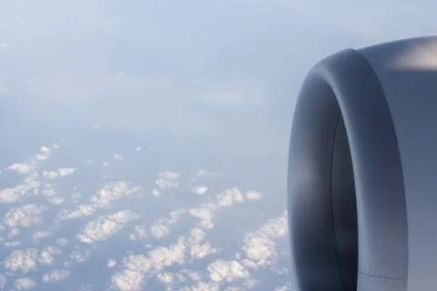 Airplane flying in sky engine wing Stock Photos