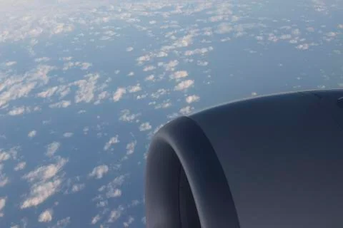 Airplane flying in sky engine wing Stock Photos