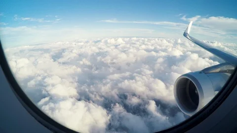 Airplane flying slightly above the clouds Stock Footage 108875347