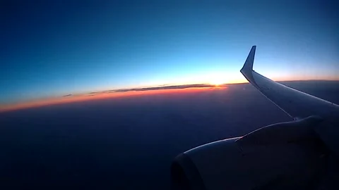 Airplane flying sunset Stock Footage 133837895