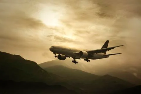 Airplane flying  at sunset Stock Photos