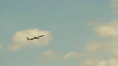 Airplane Flying Through a Blue Sky with Fluffy White Clouds HD Video Stock Footage 90956522