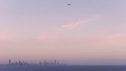 Airplane Flying Through Dusk Sky Above Surfers Paradise Skyline In Gold Coast Stock-Footage 334026412