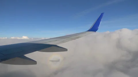 Airplane Flying Through Fluffy Clouds in 4k slow motion 60fps Stock Footage 279267871
