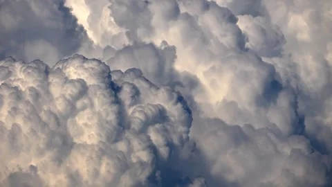 An airplane flying through huge cumulus storm clouds Stock Footage 339623401