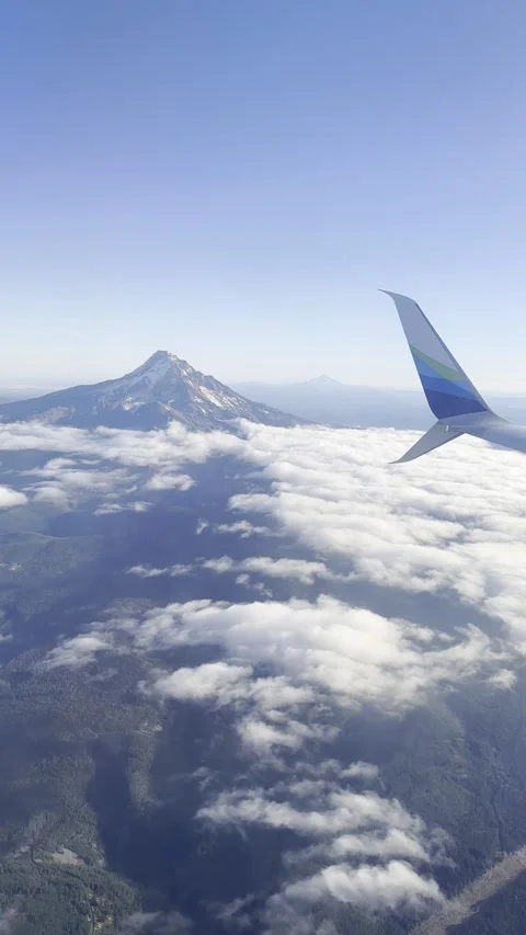Airplane flying through the mountains Stock Footage 296021805