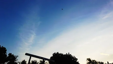 Airplane flying through the sky on a clear sunset, Bali, HD Stock Footage 158602928