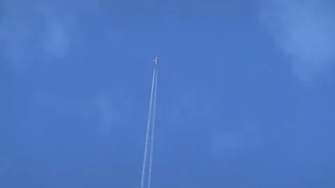 Airplane Flying Through the Sky Leaving White Contrails Stock Footage 346555473