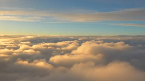 Airplane flying through white and golden clouds on a sunny day. Airplane window  Stock Footage 268447308