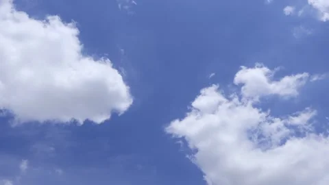 Airplane flying through white cloud leaving a long distinct contrail in blue sky Stock Footage 343945784