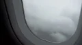 Airplane flying into turbulence zone with stormy clouds, rain on window, danger 4k or 4k+ Resolution