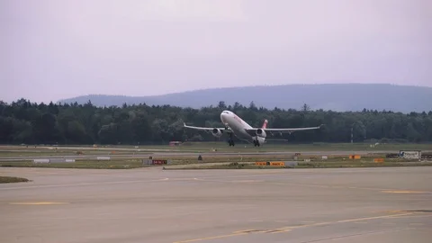 Airplane is gaining speed while moving along the runway, Plane takes off. 4K Stock Footage 121324522