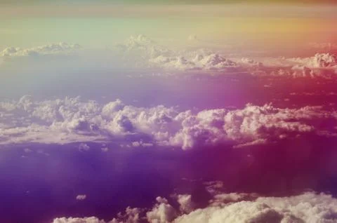 Airplane illuminator view on fluffy clouds and blue sky. Stock Photos